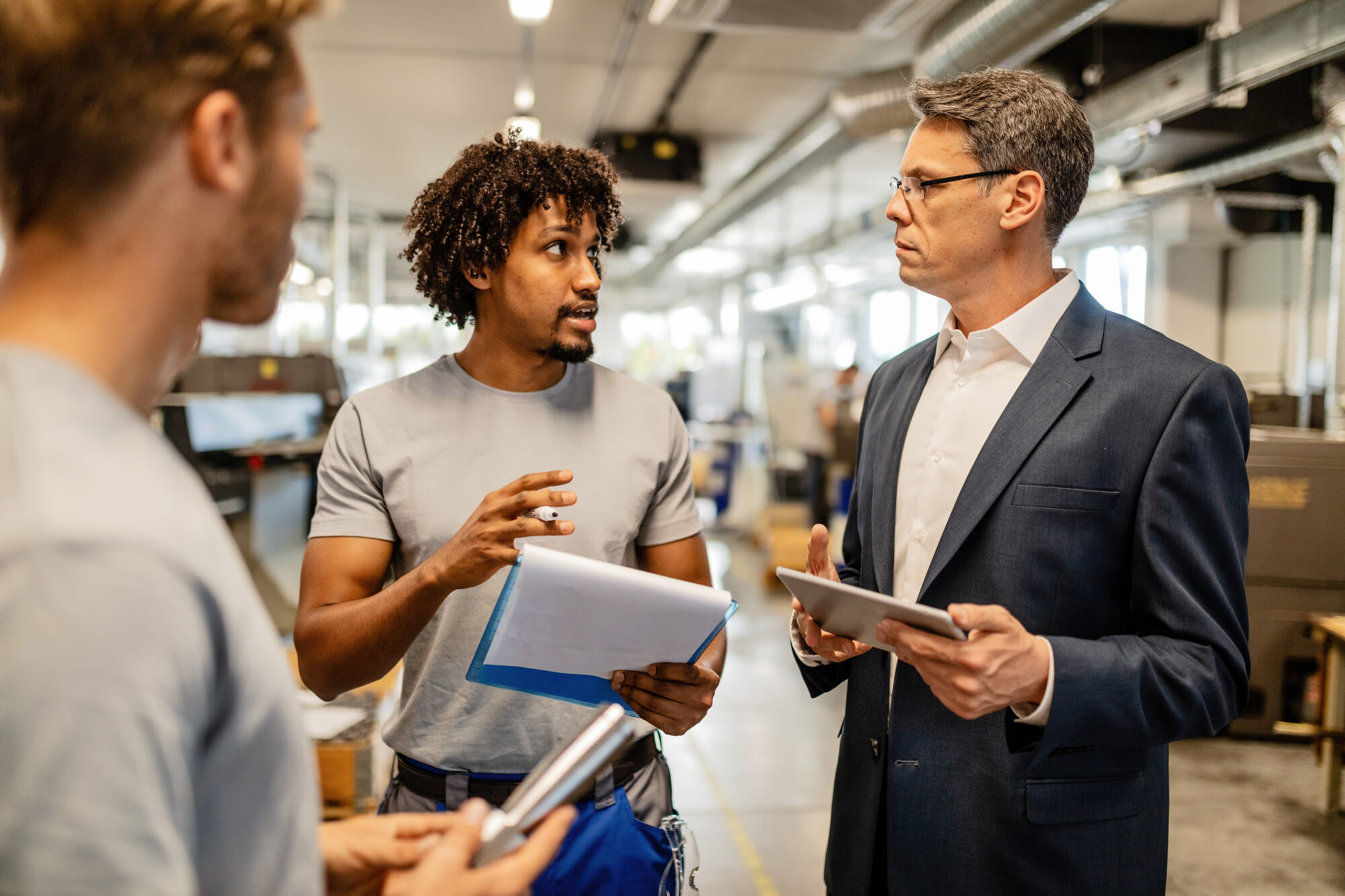 People discussing work on a factory floor